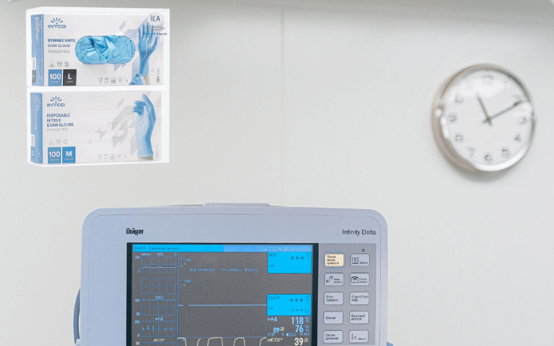 IEA Medical - Ein Diagonosegerät in der Praxis mit einem 2-Fach Handschuhspender  und einer Uhr an der Wand